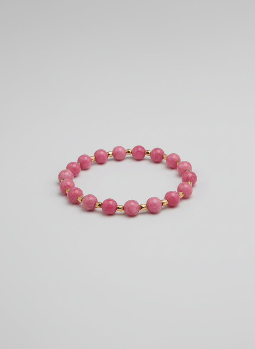 Pink beaded bracelet on a wooden surface