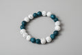 Bracelet with blue and white beads on a wooden surface