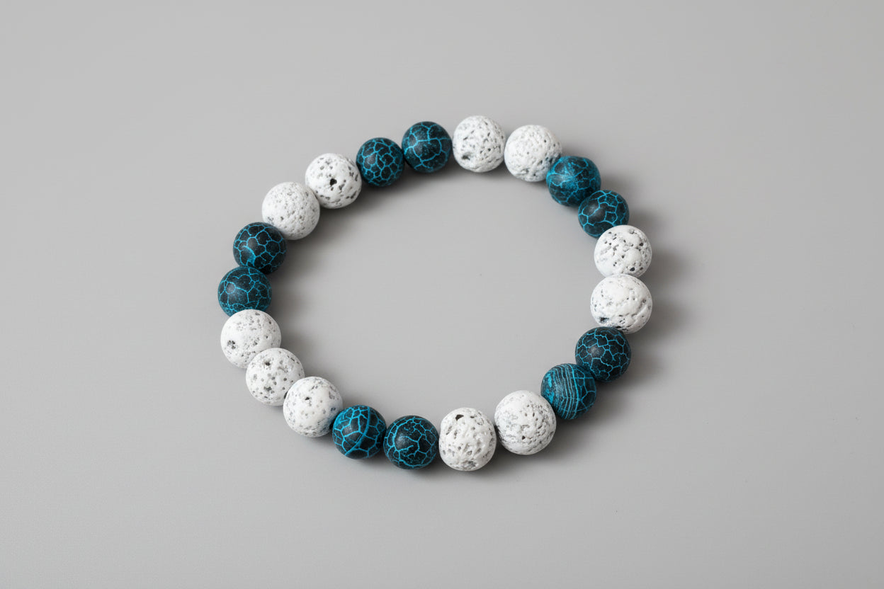 Bracelet with blue and white beads on a wooden surface