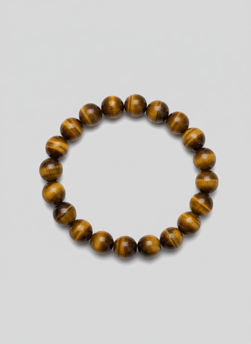 Beaded bracelet with brown and golden stones on a wooden surface