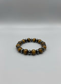 Yellow and brown beaded bracelet on a wooden surface