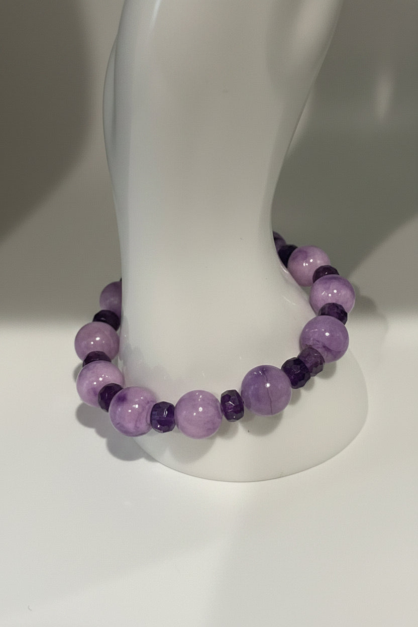 Purple Persian Gulf Chalcedony and faceted amethyst rondelle stretch bracelet on display stand