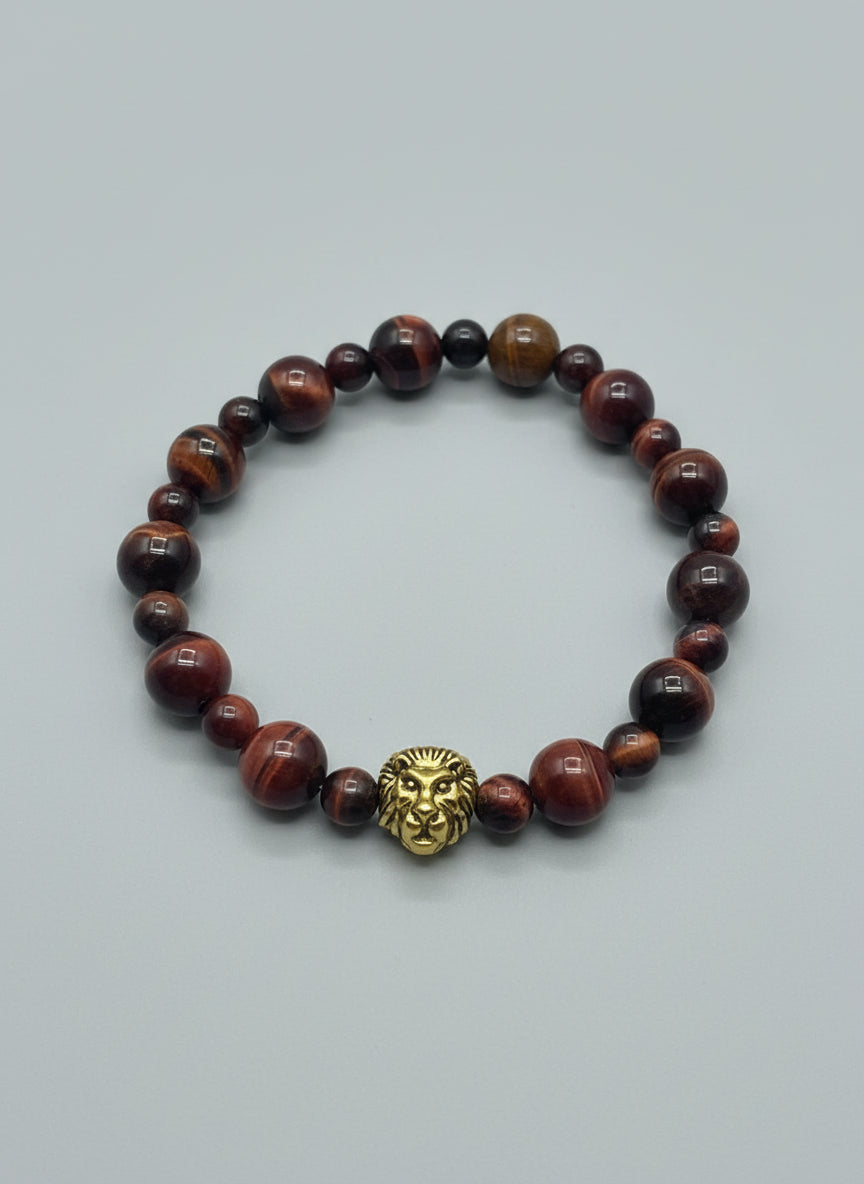 Bracelet with red tiger eye beads on a wooden surface
