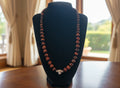 Red Tiger Eye Beaded necklace on a black velvet stand 