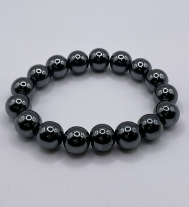 Black beaded bracelet on a light gray background