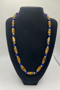 Beaded necklace on a black bust with a white background