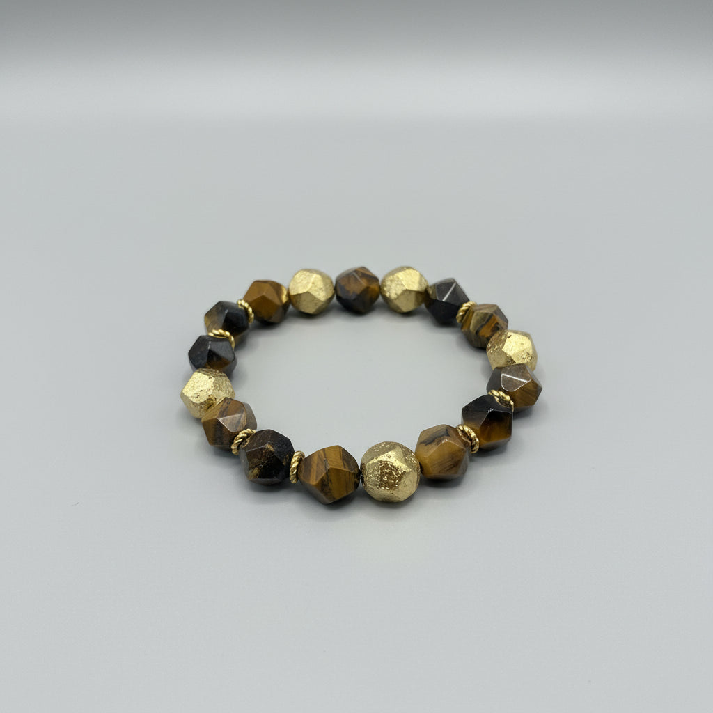 Beaded bracelet with gold and brown beads on a gray background