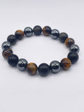 Beaded bracelet with black and brown beads on a white background