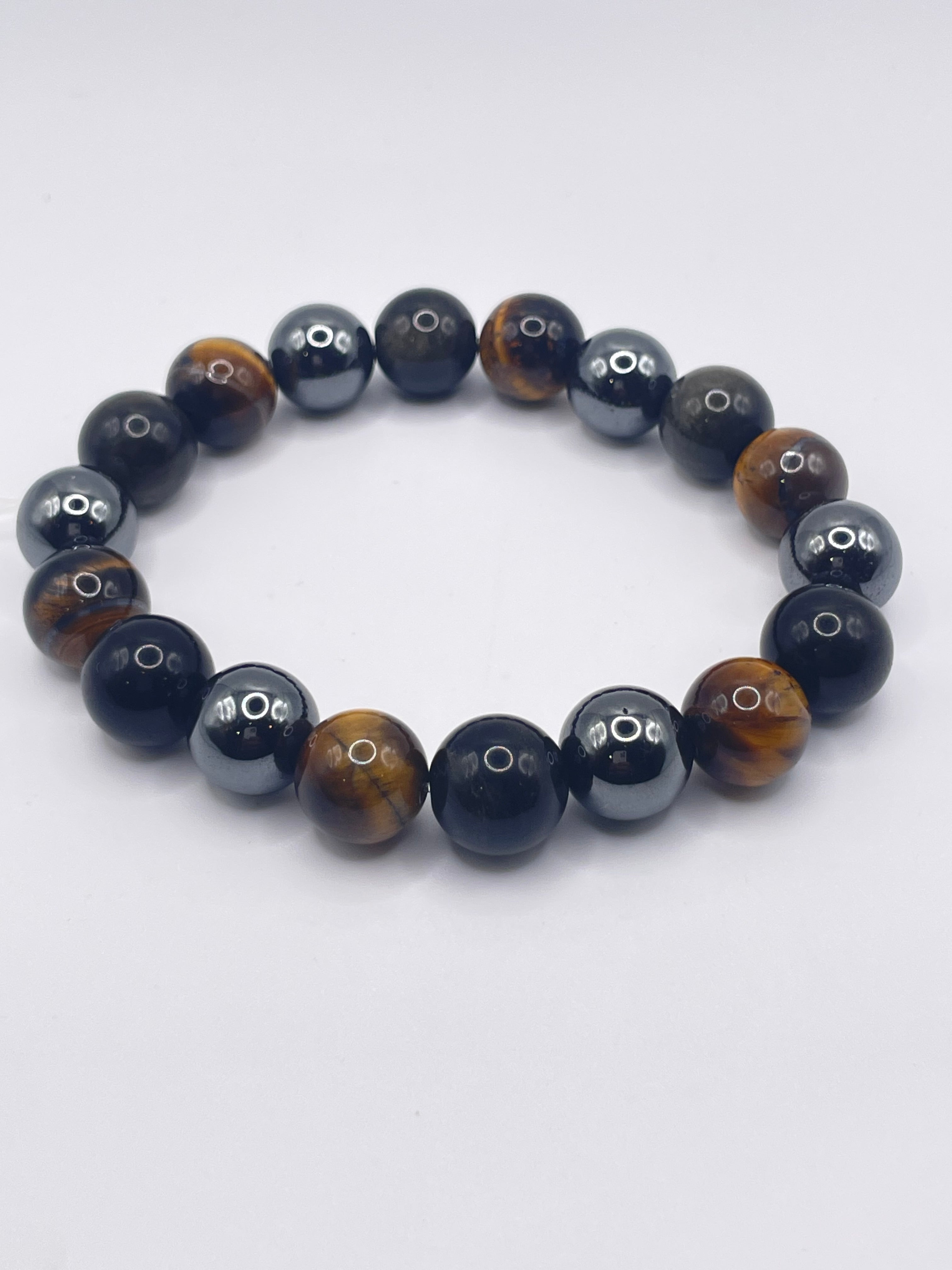 Beaded bracelet with black and brown beads on a white background