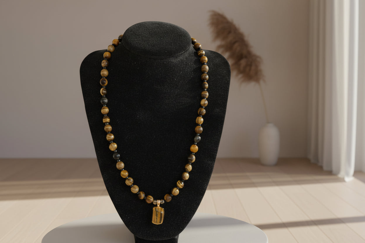 Beaded necklace on a black stand with a wooden surface in the background