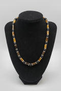 Tiger Eye Cylinder Choker Necklace with 18K Gold Hematite Spacers on black velvet bust display