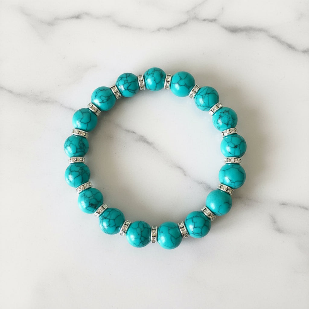 Turquoise beaded bracelet with rhinestones spacer on marble surface