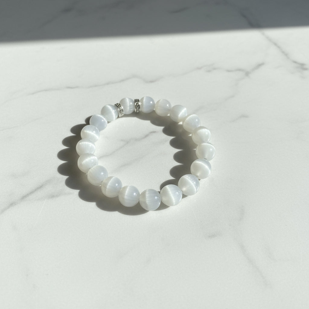 White beaded bracelet on a marble surface