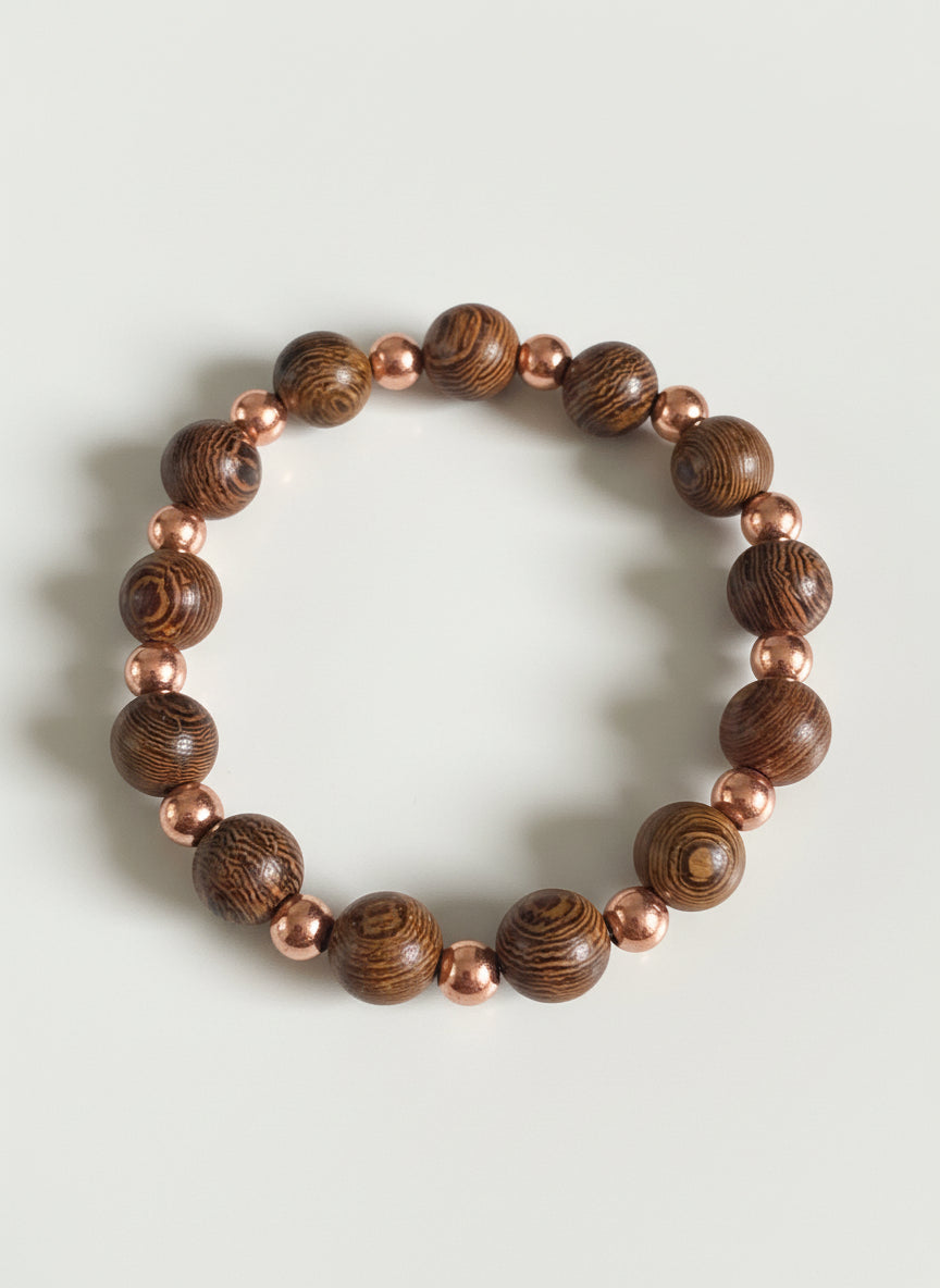 Bracelet made of brown and gold beaded materials on a dark textured surface