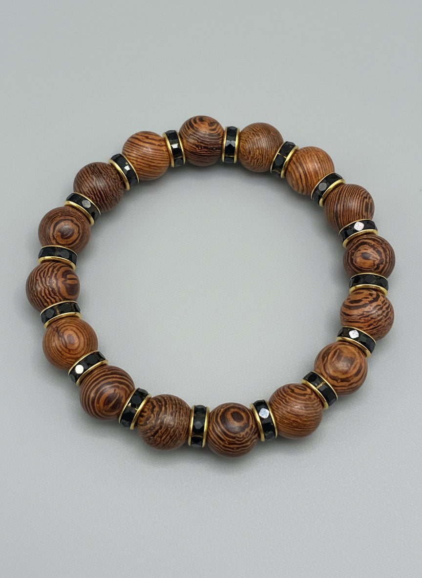 Wooden beaded and black rhinestones spacers bracelet on a textured gray background black rhinest