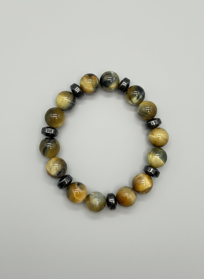 Beaded bracelet with yellow gray and black beads on a wooden surface