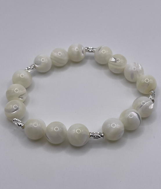 White beaded bracelet on a light gray background